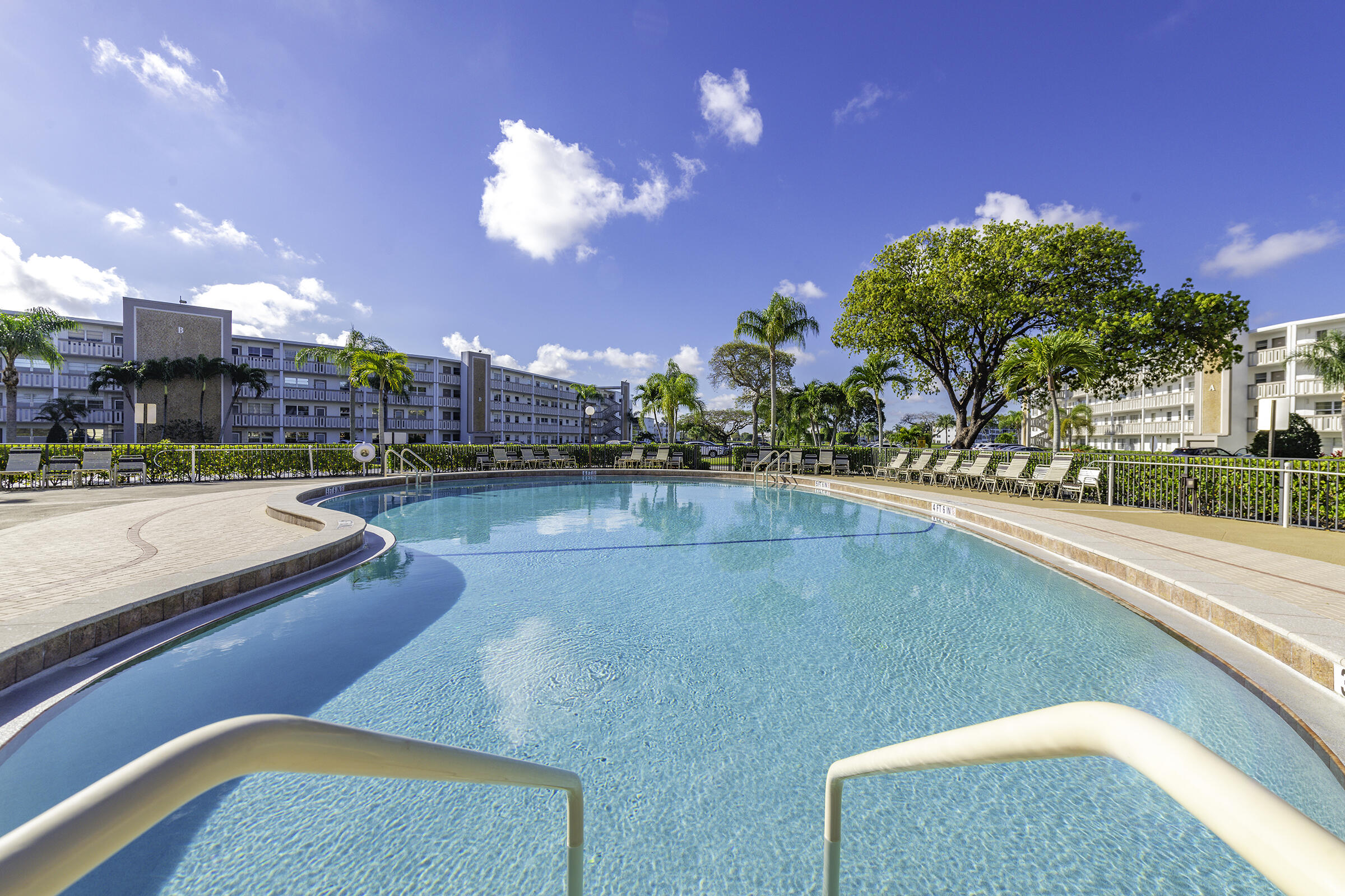 4043 Rexford Drive, Unit 4043 Boca Raton, FL 33434 - Photo 22 of 27 a view of a swimming pool and a chairs