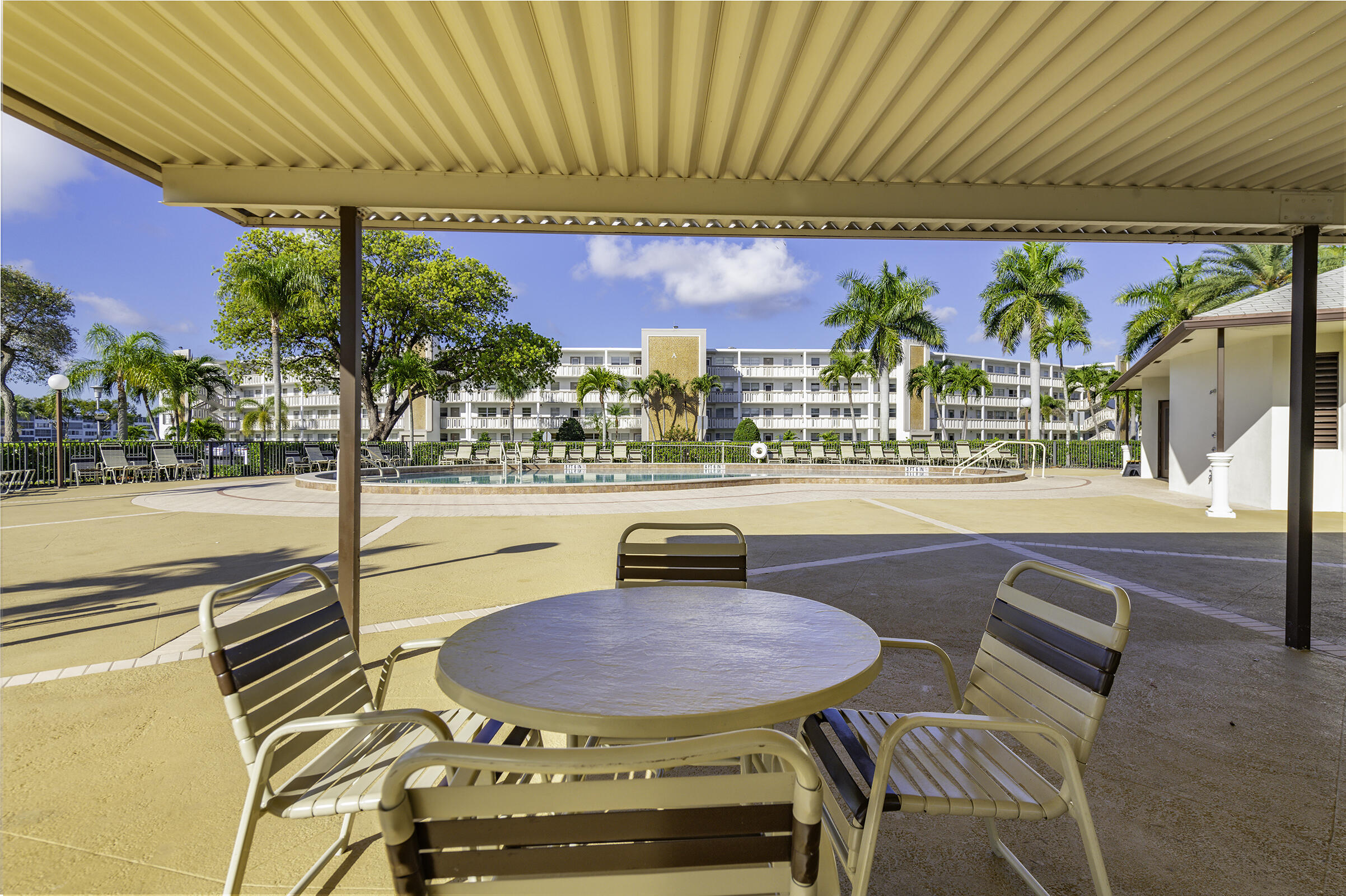 4043 Rexford Drive, Unit 4043 Boca Raton, FL 33434 - Photo 24 of 27 a swimming pool with outdoor seating