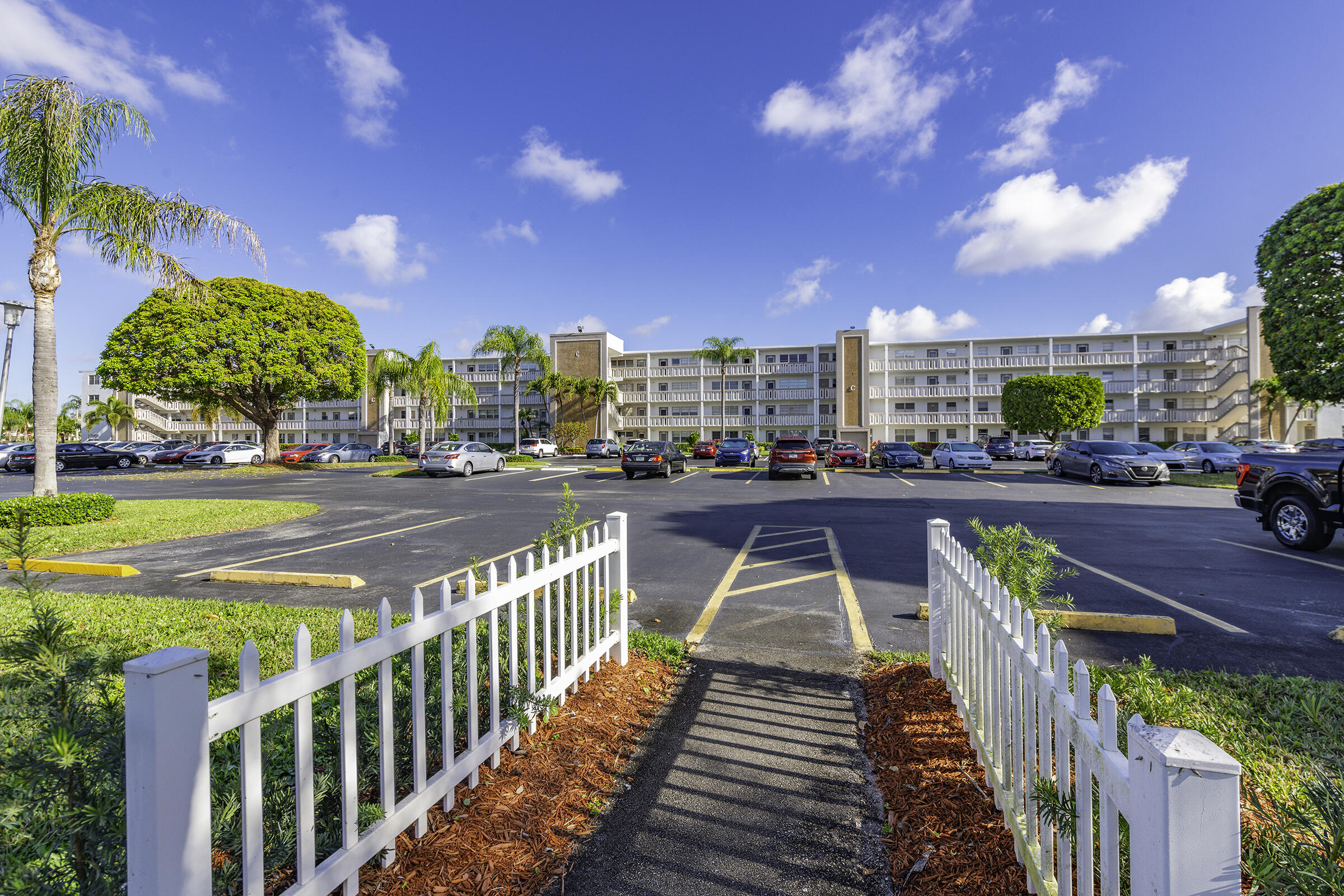 4043 Rexford Drive, Unit 4043 Boca Raton, FL 33434 - Photo 25 of 27 a view of a swimming pool with a deck and a potted plants
