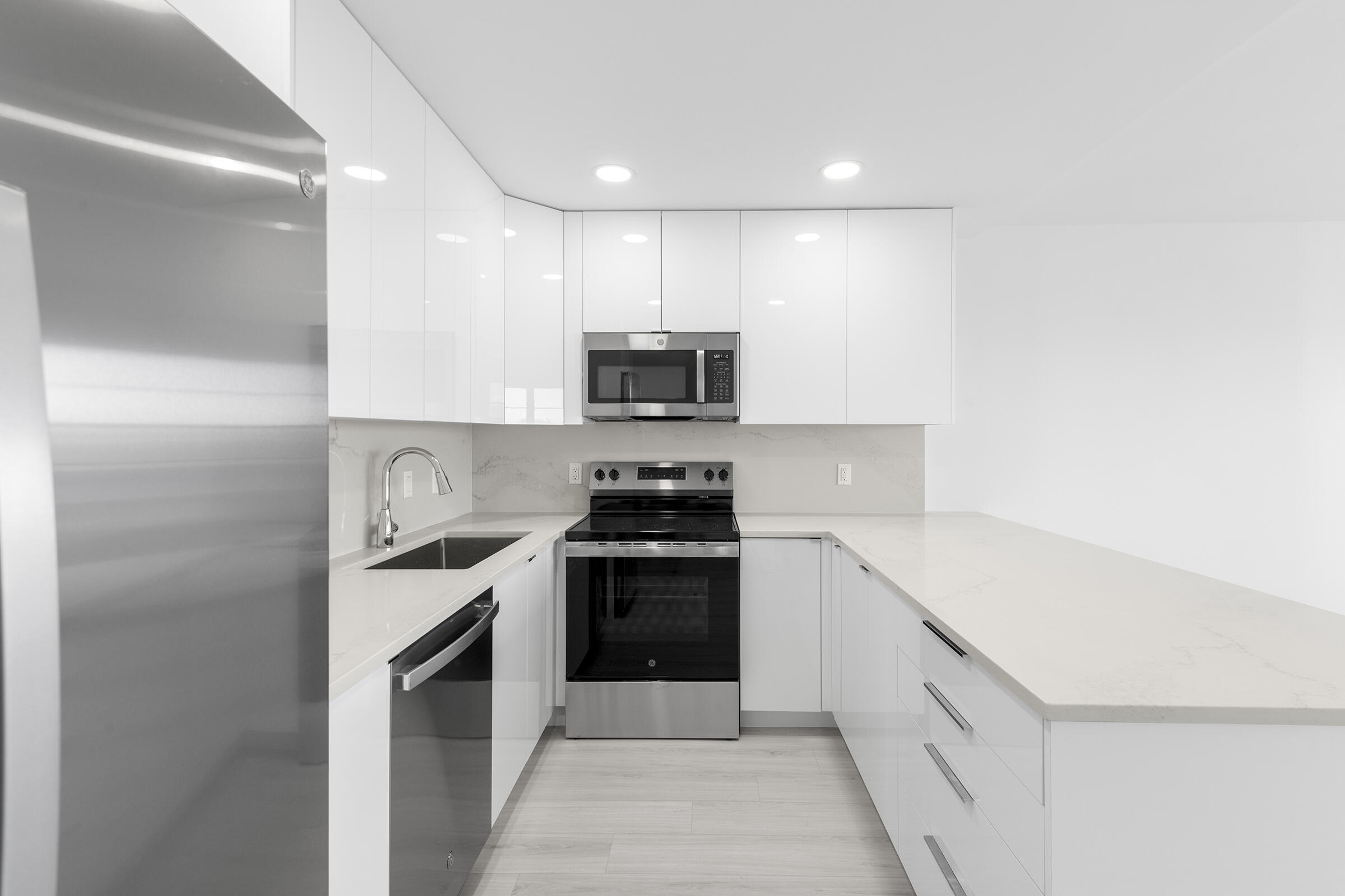 4043 Rexford Drive, Unit 4043 Boca Raton, FL 33434 - Photo 6 of 27 a kitchen with a sink and a stove top oven