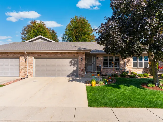 a front view of a house with a garden and patio