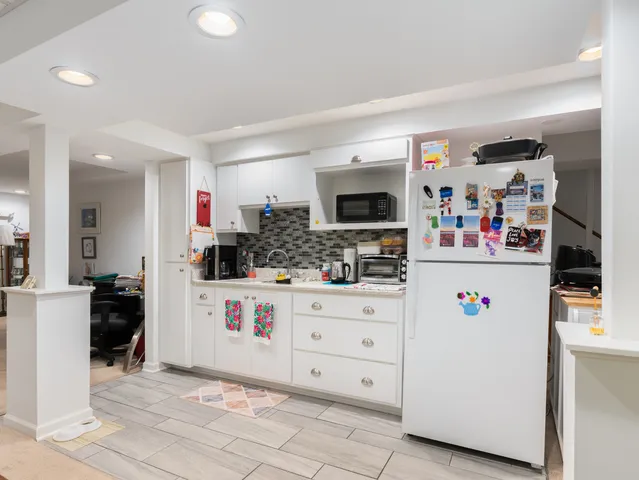 a kitchen with refrigerator and cabinets