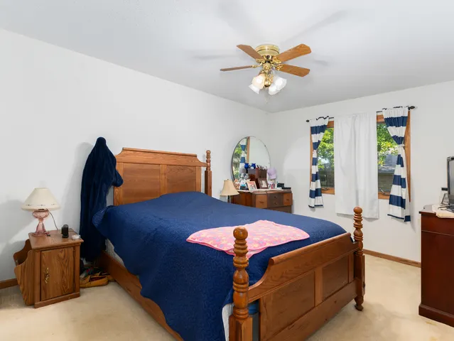 a bedroom with a bed and a table in it