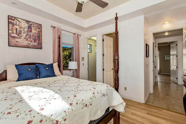 a view of a livingroom with wooden floor and furniture
