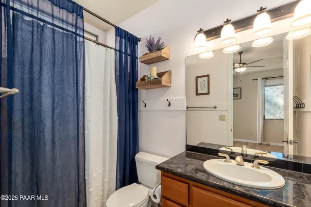 a kitchen with stainless steel appliances granite countertop a sink and a refrigerator