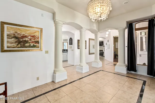 a spacious bedroom with a bed a table and a fireplace