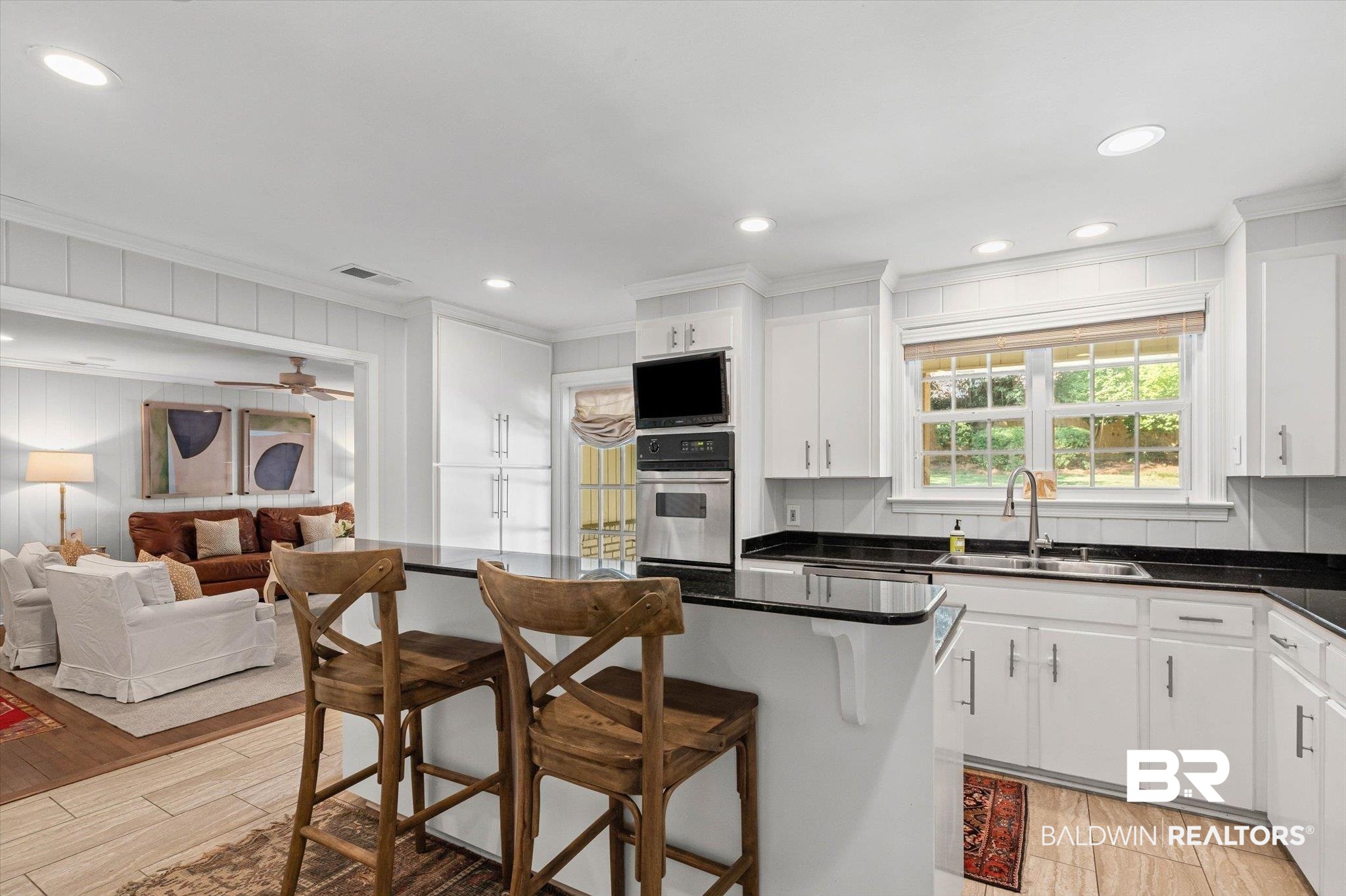 313 Brawood Drive Mobile, AL 36608 - Photo 7 of 32 Kitchen with crown molding, a breakfast bar, white cabinetry, recessed lighting, and stainless steel oven
