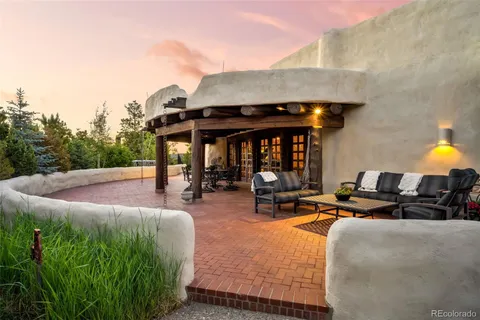 a view of a patio with a couch and a fire pit