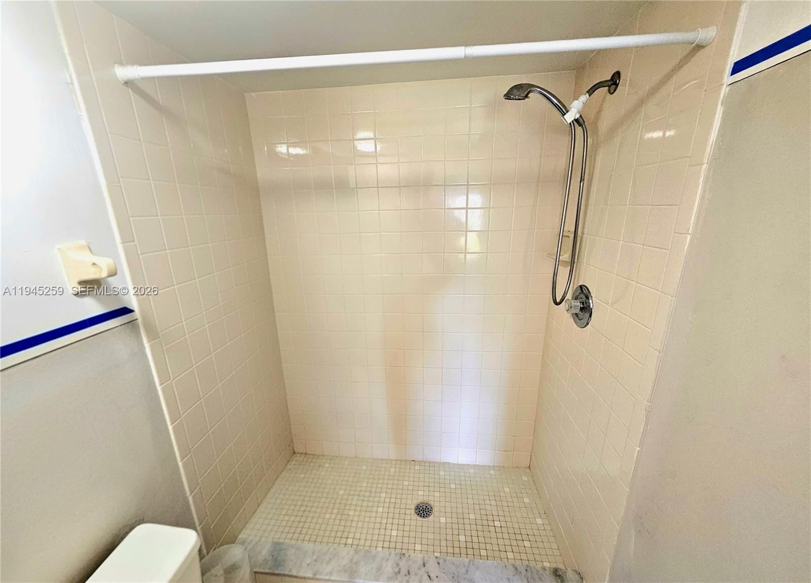 1448 Churchill Circle, Unit 103 Naples, FL 34116 - Photo 13 of 37 a bathroom with a shower and a toilet