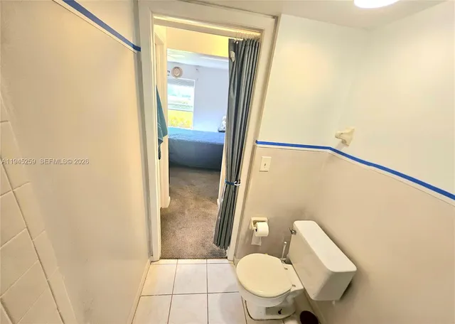 a bathroom with a granite countertop sink mirror vanity and toilet