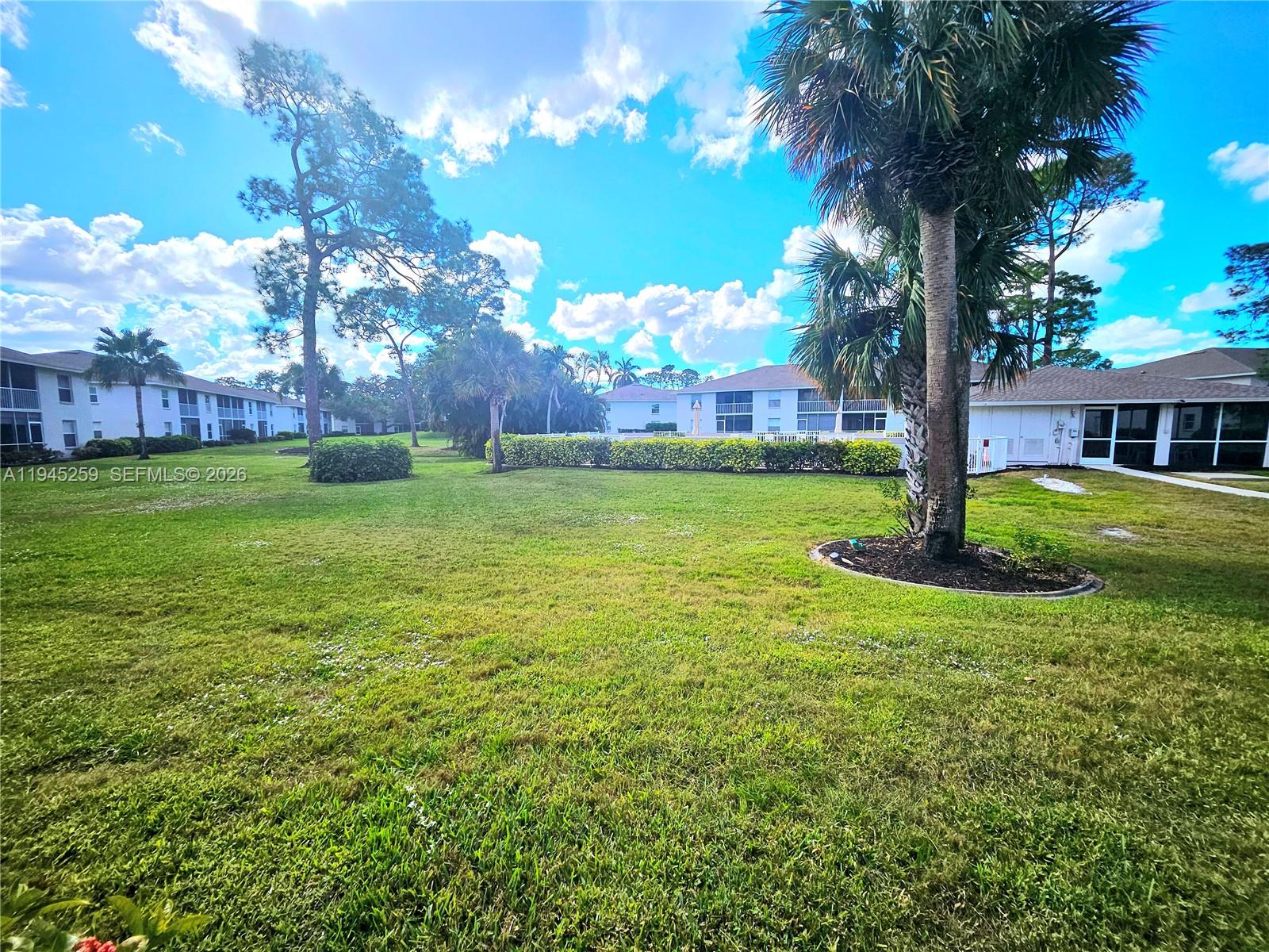 1448 Churchill Circle, Unit 103 Naples, FL 34116 - Photo 29 of 37 a view of a house with a big yard