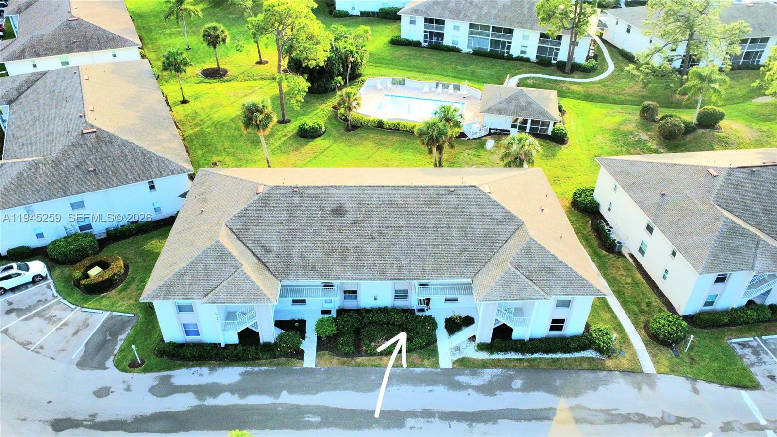 1448 Churchill Circle, Unit 103 Naples, FL 34116 - Photo 31 of 37 an aerial view of a house with a swimming pool