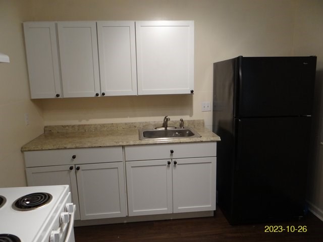 5664 St Marys Road, Unit B Columbus, GA 31907 - Photo 7 of 13 a kitchen with a refrigerator and cabinets