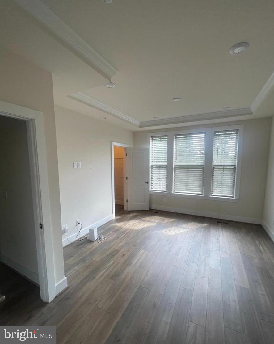 2228 South Glebe Road Arlington, VA 22204 - Photo 11 of 34 an empty room with wooden floor and windows