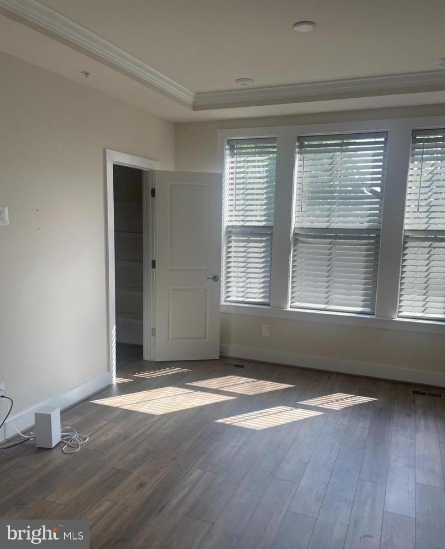 2228 South Glebe Road Arlington, VA 22204 - Photo 12 of 34 an empty room with wooden floor and windows
