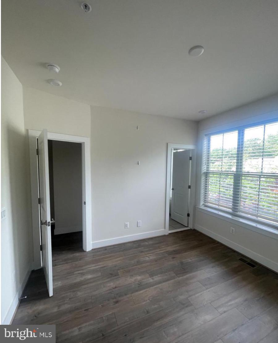 2228 South Glebe Road Arlington, VA 22204 - Photo 13 of 34 an empty room with wooden floor and windows