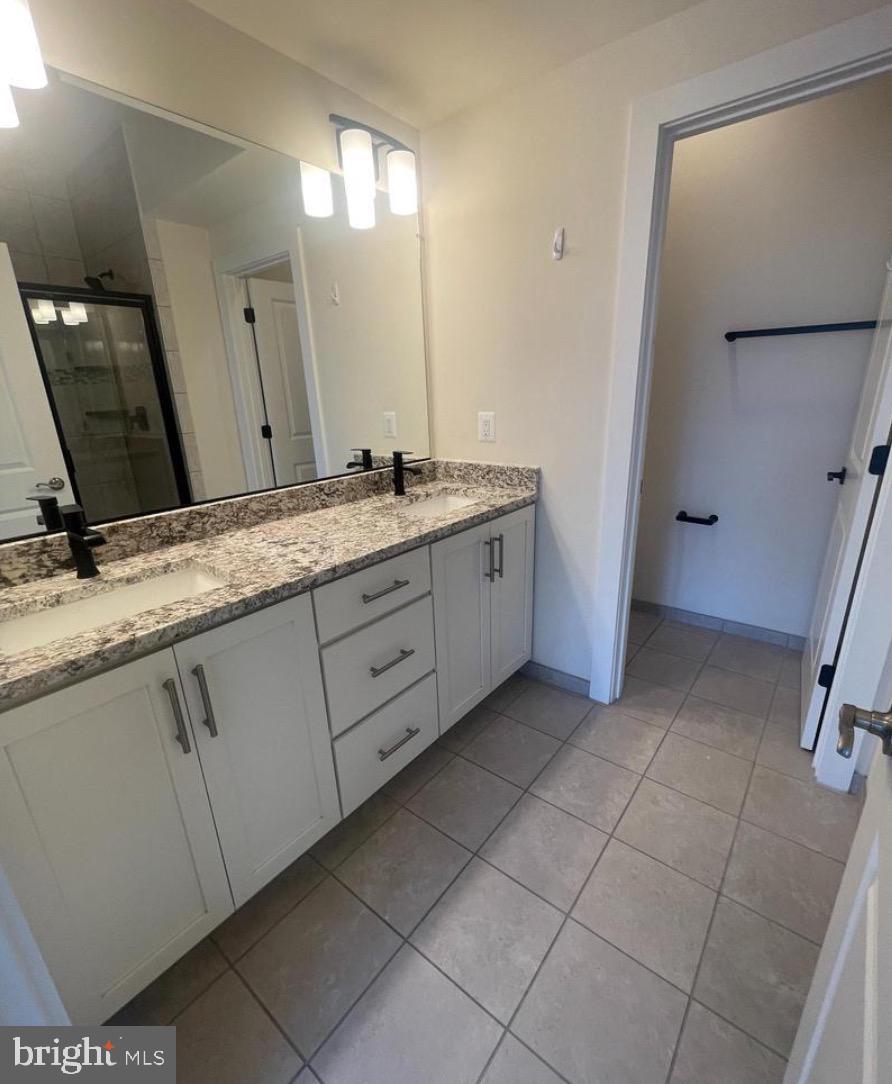 2228 South Glebe Road Arlington, VA 22204 - Photo 14 of 34 a bathroom with a granite countertop sink and a mirror