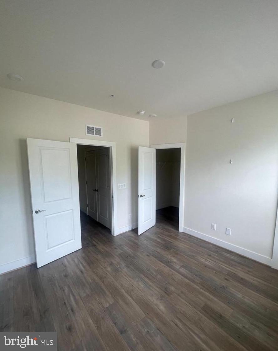 2228 South Glebe Road Arlington, VA 22204 - Photo 16 of 34 a view of an empty room with wooden floor and closet