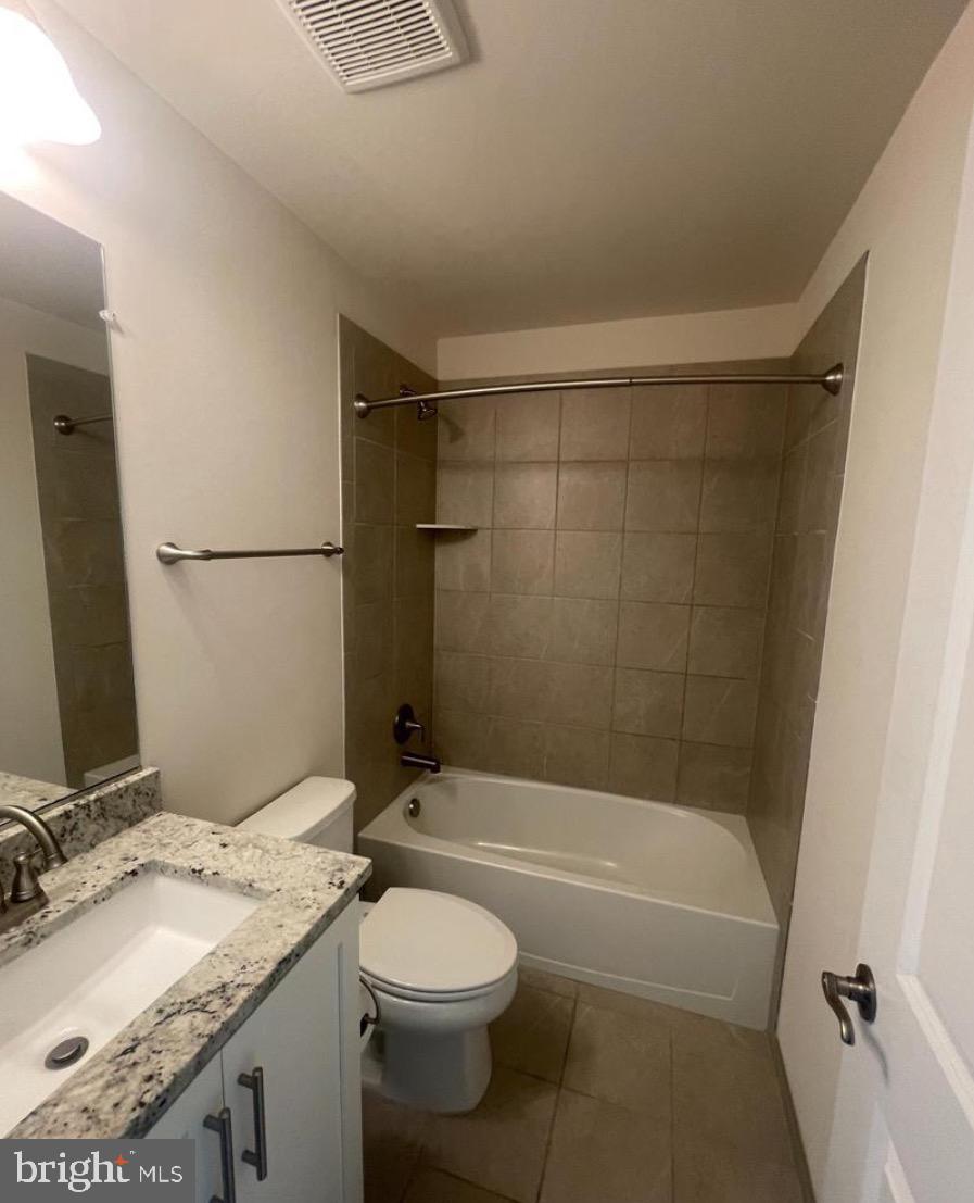 2228 South Glebe Road Arlington, VA 22204 - Photo 21 of 34 a bathroom with a granite countertop bathtub shower sink vanity and toilet