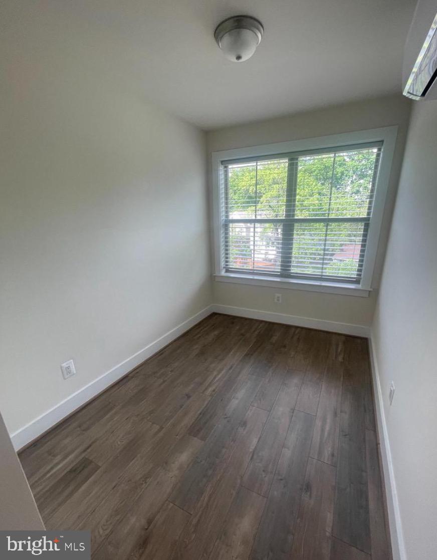 2228 South Glebe Road Arlington, VA 22204 - Photo 25 of 34 an empty room with wooden floor and windows
