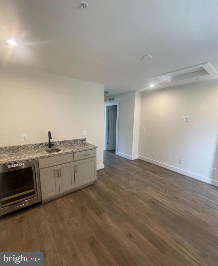 2228 South Glebe Road Arlington, VA 22204 - Photo 29 of 34 a open kitchen with a sink and dishwasher a stove top oven with wooden floor
