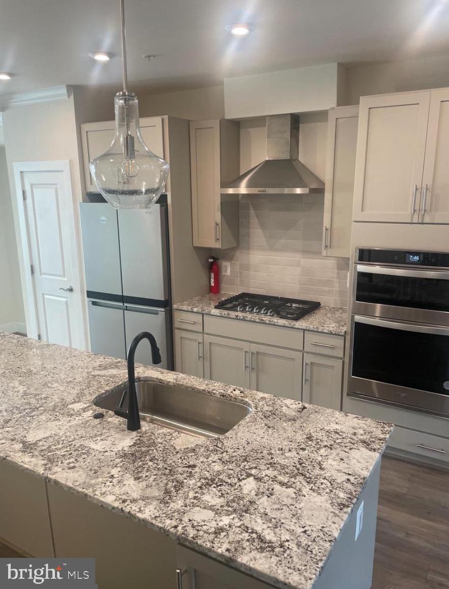 2228 South Glebe Road Arlington, VA 22204 - Photo 5 of 34 a kitchen with granite countertop a sink stainless steel appliances and cabinets