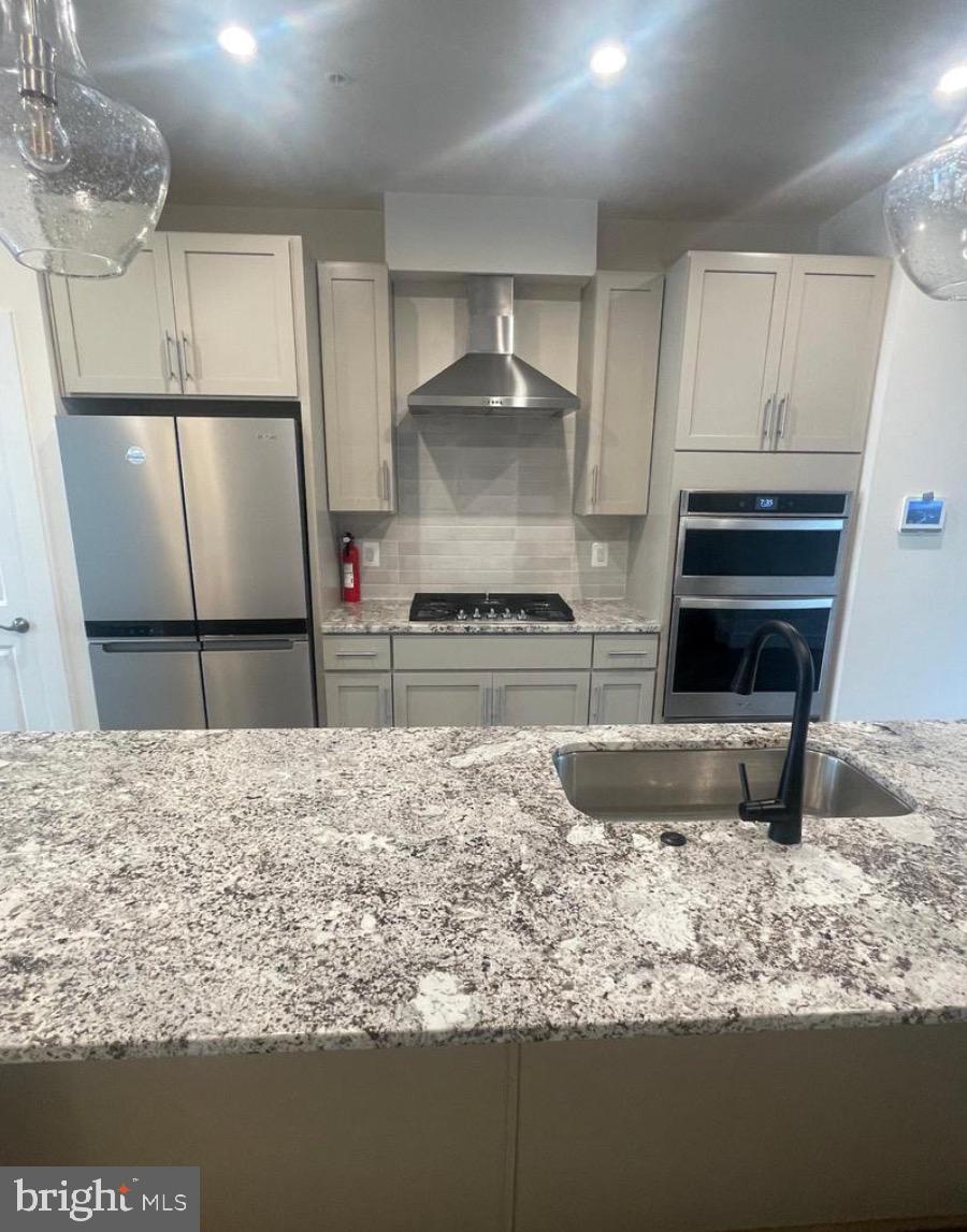 2228 South Glebe Road Arlington, VA 22204 - Photo 8 of 34 a kitchen with granite countertop a refrigerator and a stove top oven