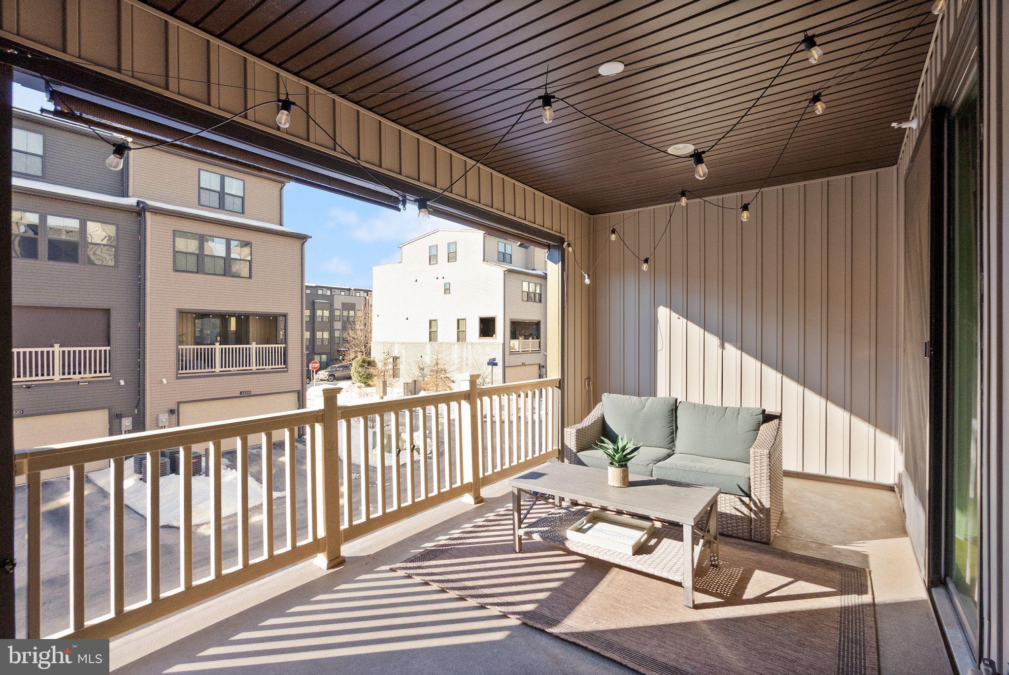 43405 Charitable Street Ashburn, VA 20148 - Photo 15 of 44 a balcony with wooden floor and outdoor seating