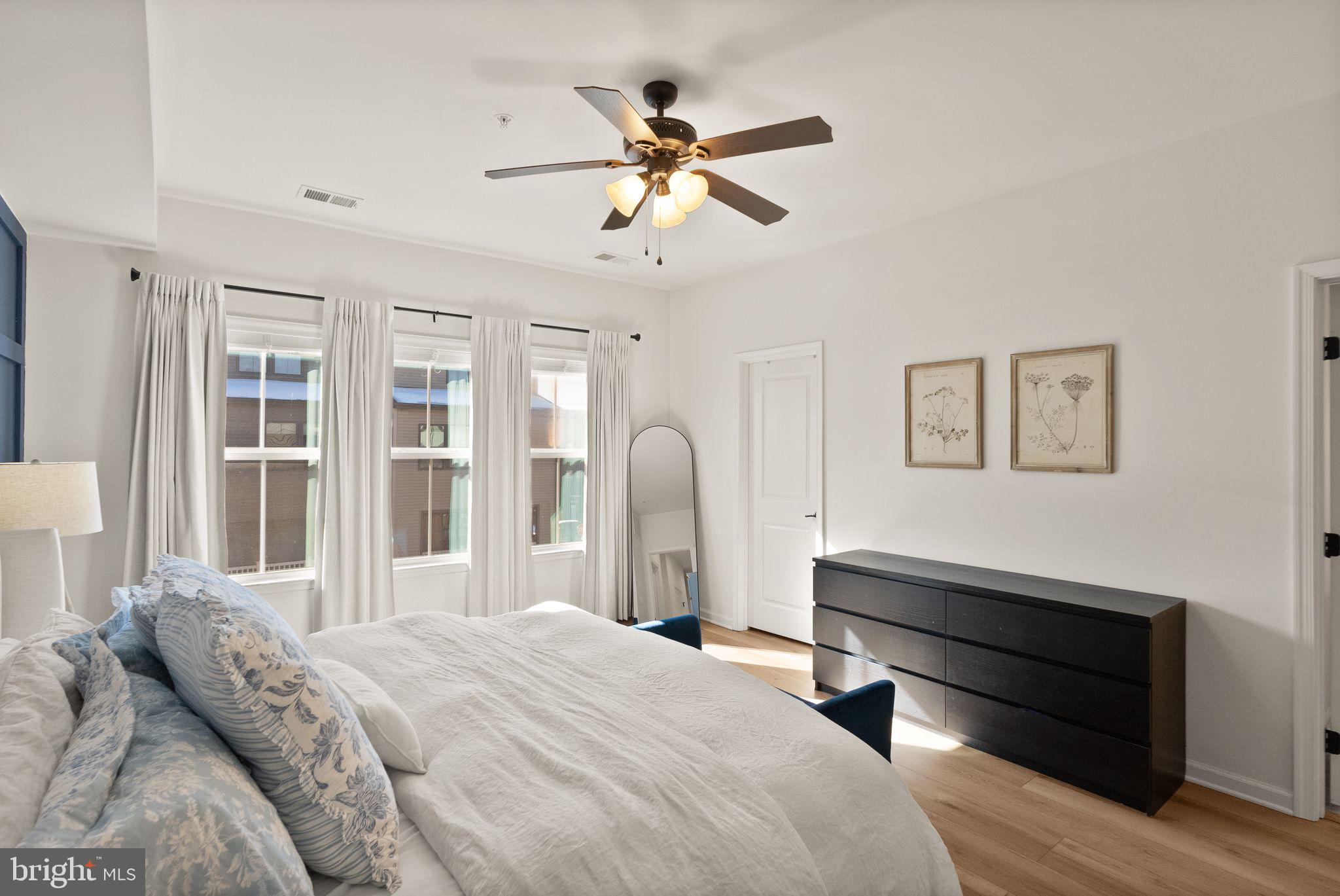 43405 Charitable Street Ashburn, VA 20148 - Photo 19 of 44 a bedroom with a bed and a chandelier