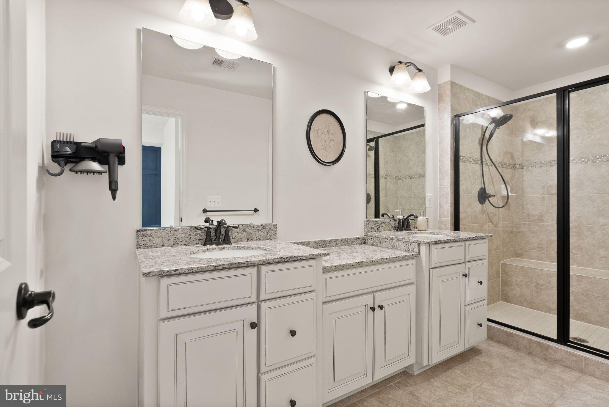 43405 Charitable Street Ashburn, VA 20148 - Photo 21 of 44 a bathroom with a double vanity sink mirror and shower