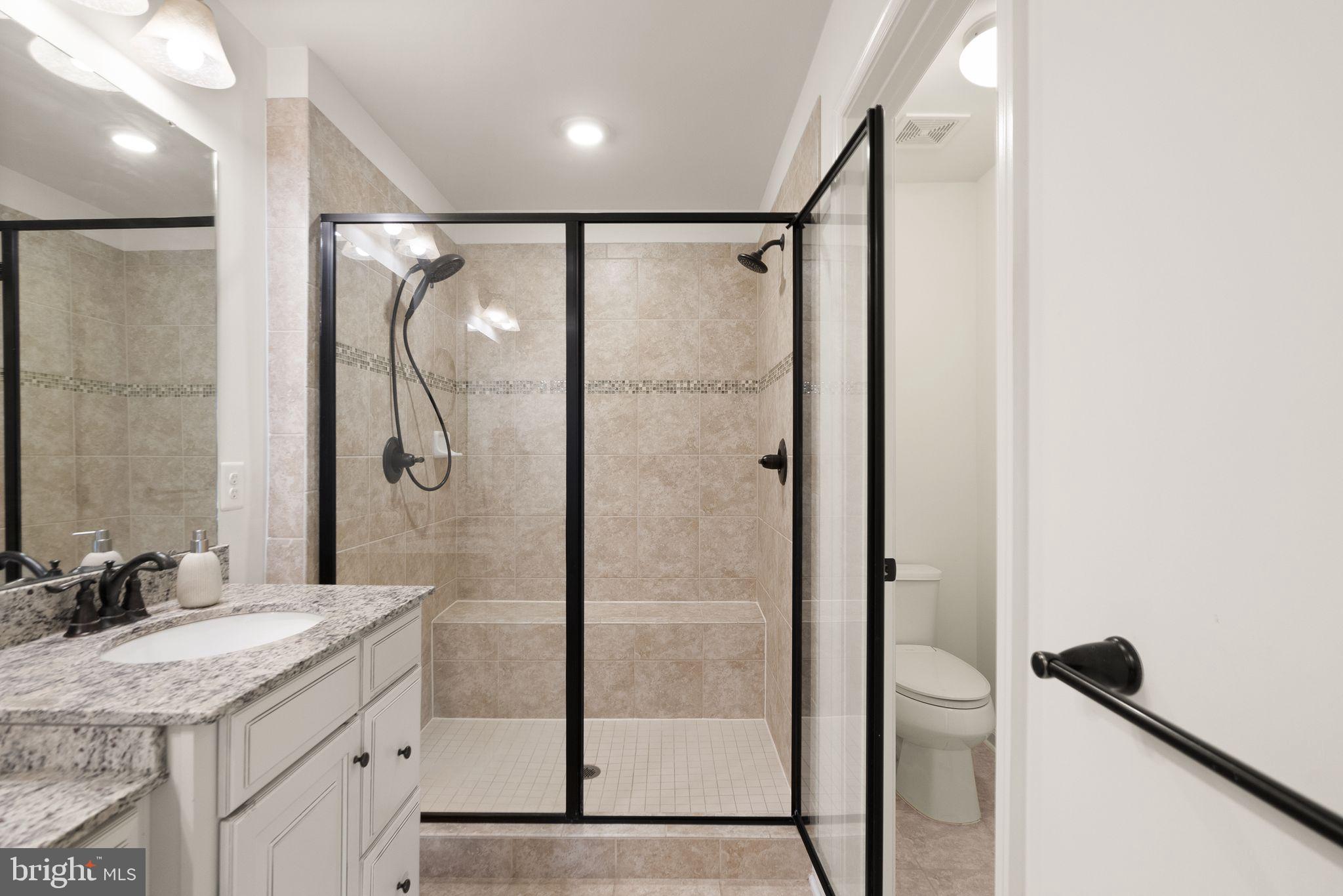 43405 Charitable Street Ashburn, VA 20148 - Photo 22 of 44 a bathroom with a granite countertop shower sink vanity and mirror