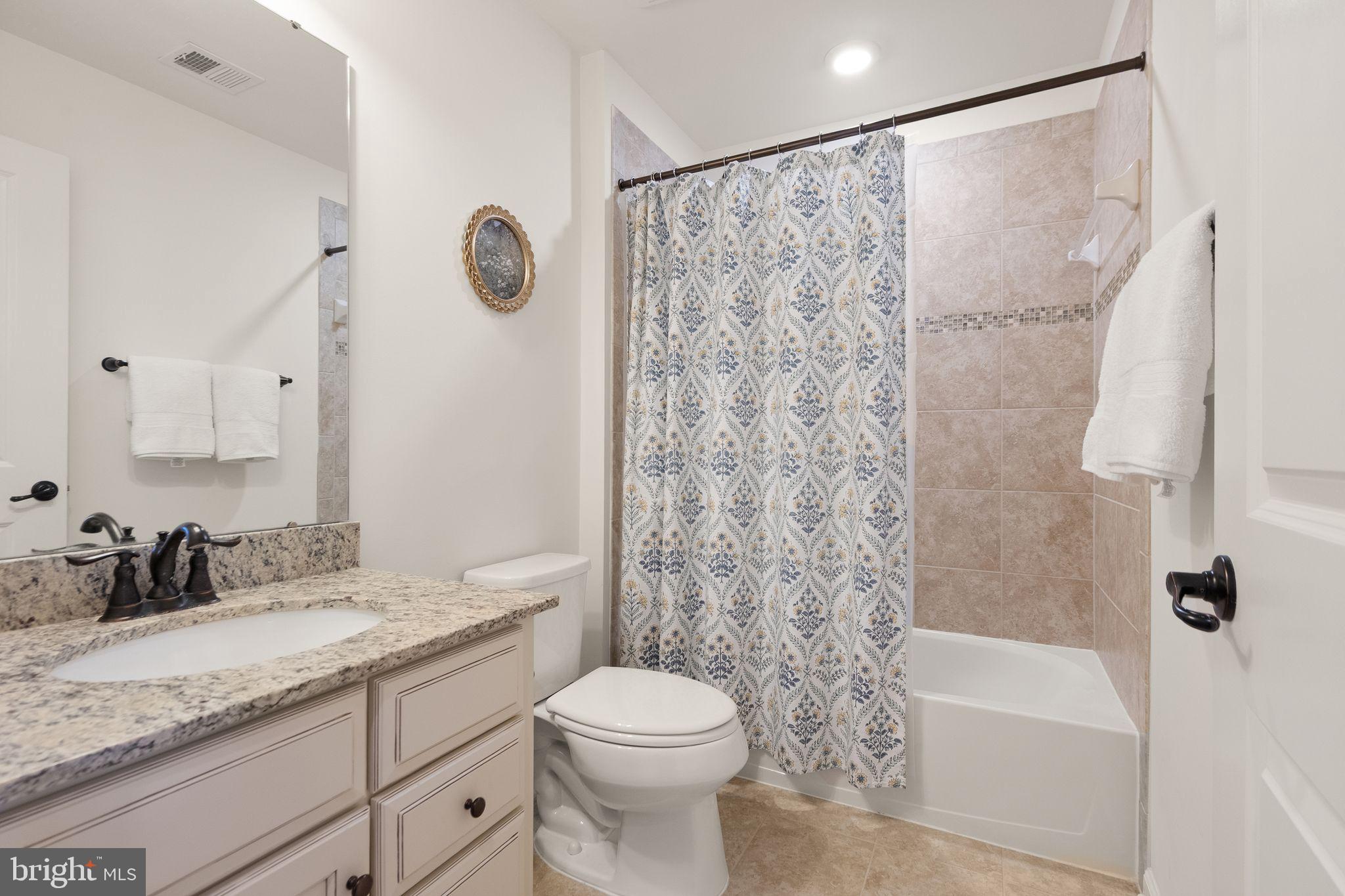 43405 Charitable Street Ashburn, VA 20148 - Photo 27 of 44 a bathroom with a granite countertop sink toilet and shower