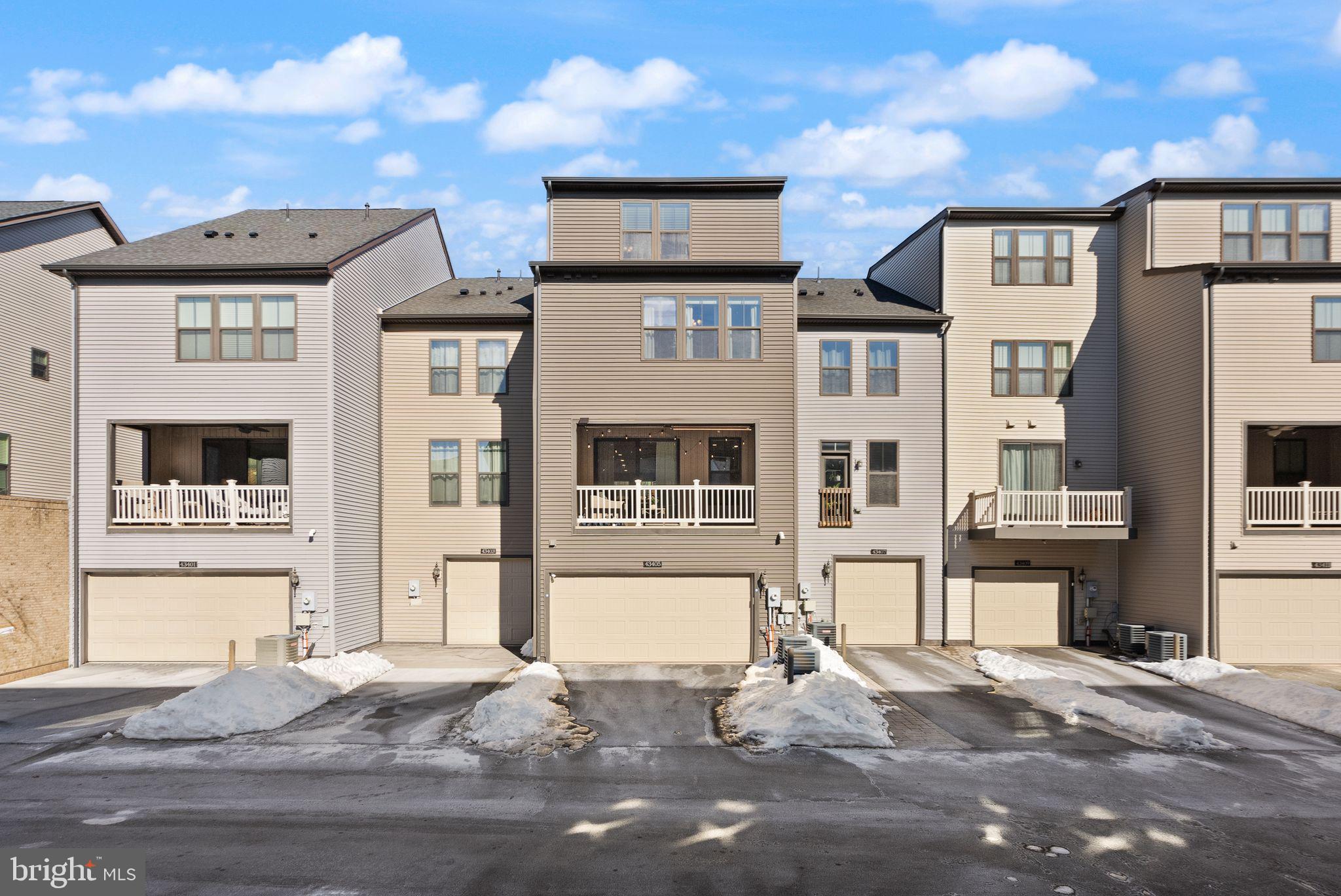 43405 Charitable Street Ashburn, VA 20148 - Photo 34 of 44 a front view of a residential apartment building with a yard