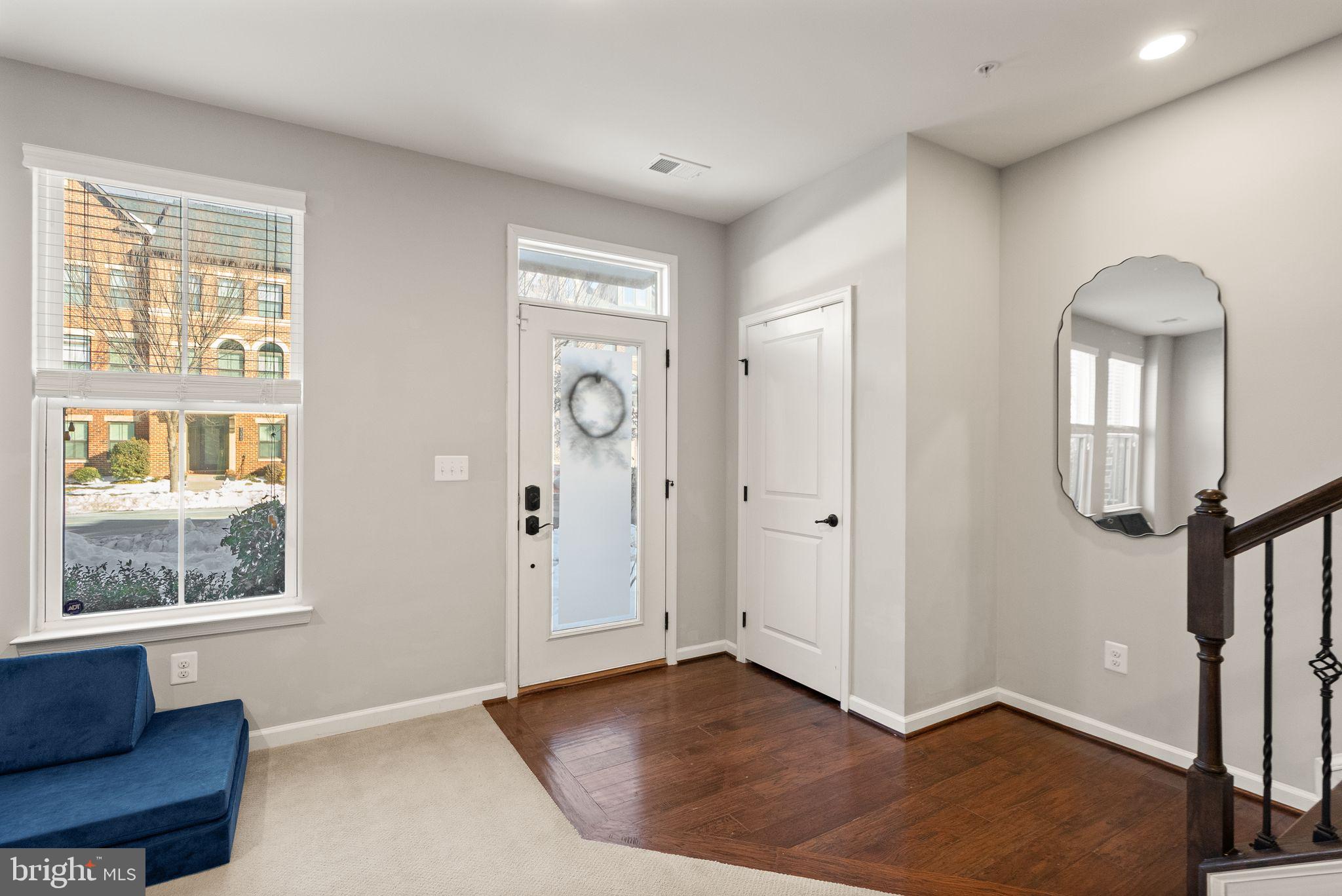 43405 Charitable Street Ashburn, VA 20148 - Photo 4 of 44 a view of an empty room with a window and wooden floor