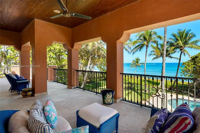 a front view of a house with fountain table and chairs