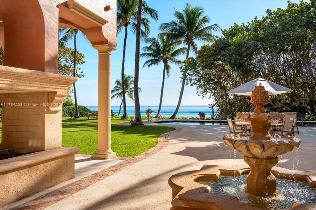 a view of a swimming pool and palm trees