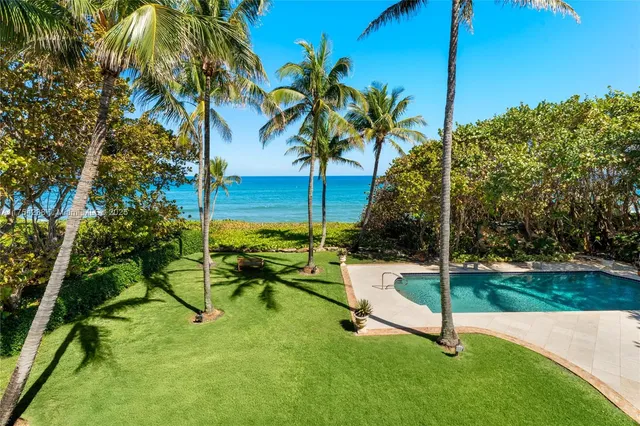 a living room with fireplace furniture and a large window