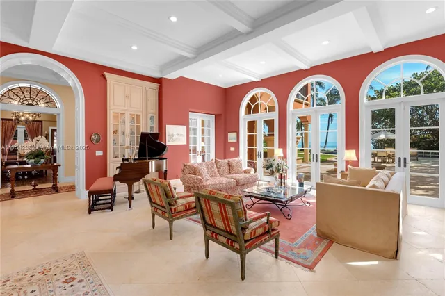 a living room with fireplace furniture and a large window