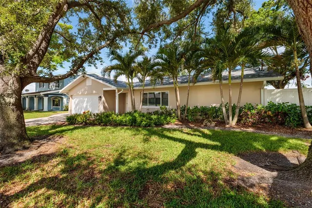 a view of backyard of house with green space