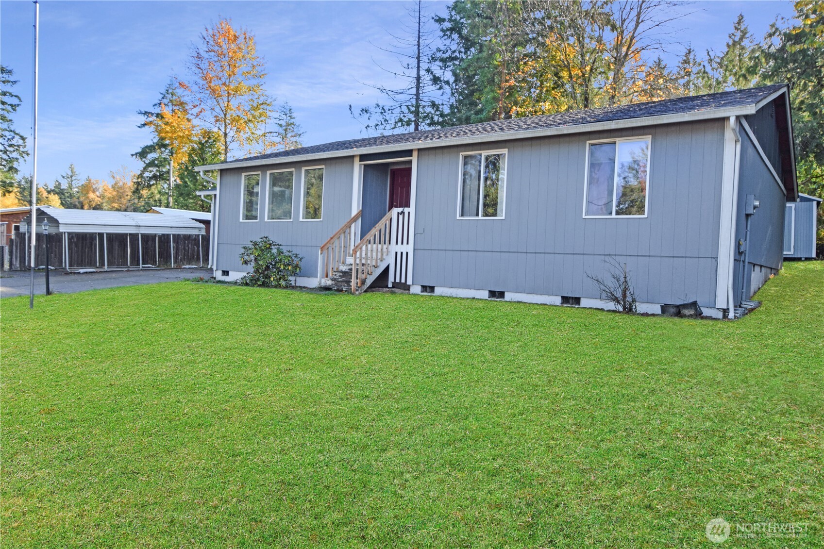 a view of a house with a yard and porch