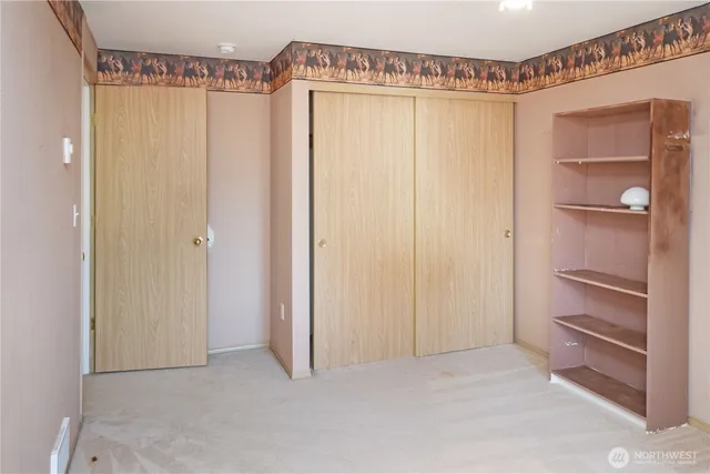a view of a room with wooden floor and closet