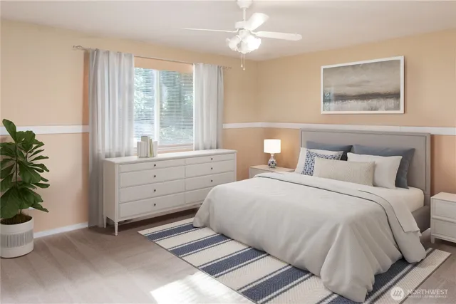 a bedroom with a large bed and a potted plant