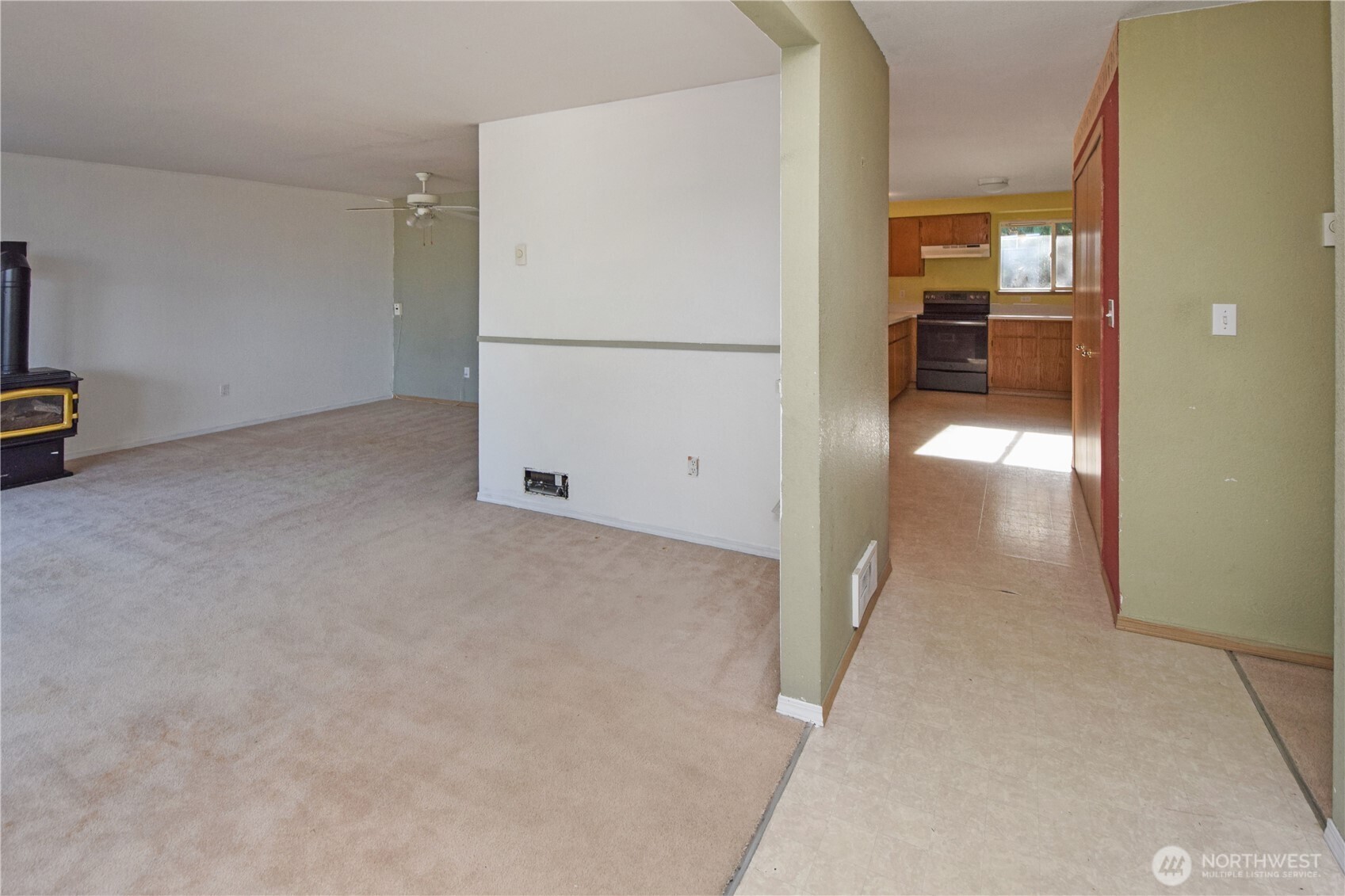 221 East 5th Street Union, WA 98592 - Photo 10 of 32 a view of a kitchen with a refrigerator a stove top oven and a refrigerator