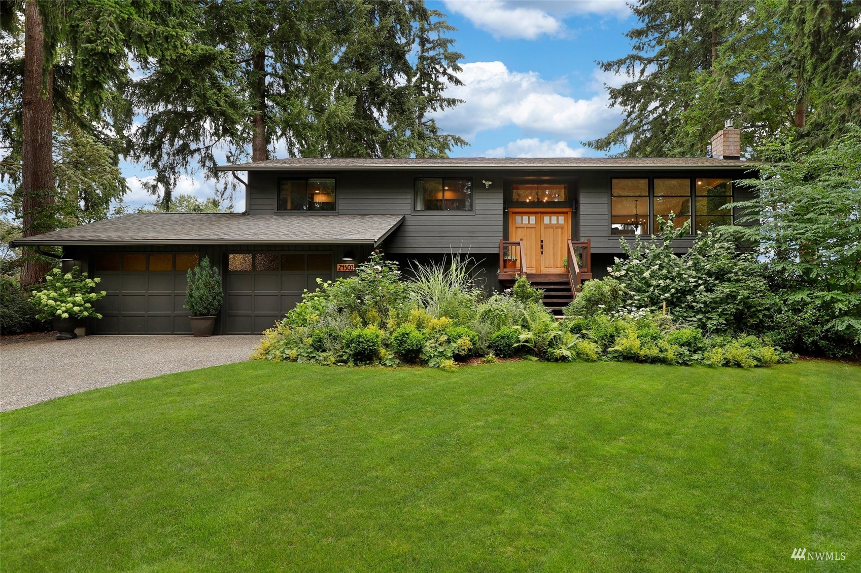24301 23rd Avenue West Bothell, WA 98021 - Photo 1 of 39 a front view of a house with a garden