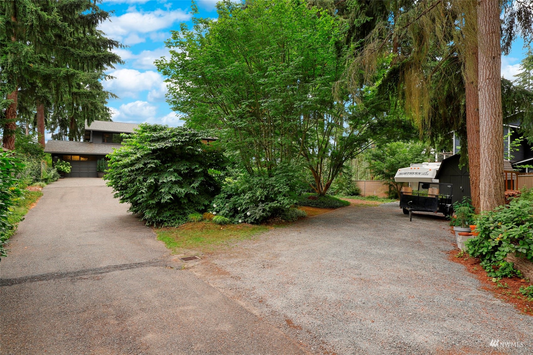 24301 23rd Avenue West Bothell, WA 98021 - Photo 36 of 39 a view of a street with potted plants and a large tree