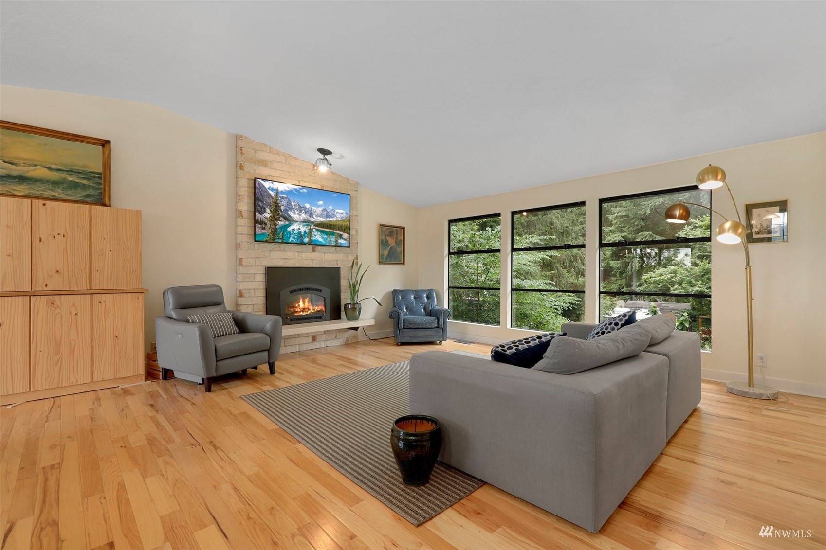 24301 23rd Avenue West Bothell, WA 98021 - Photo 5 of 39 a living room with furniture a fireplace and a floor to ceiling window