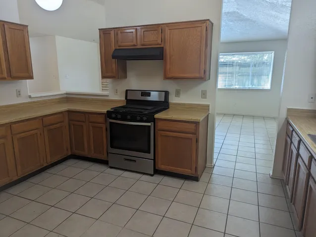 a kitchen with a cabinets and a stove top oven