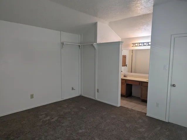 a view of an empty room with a kitchen