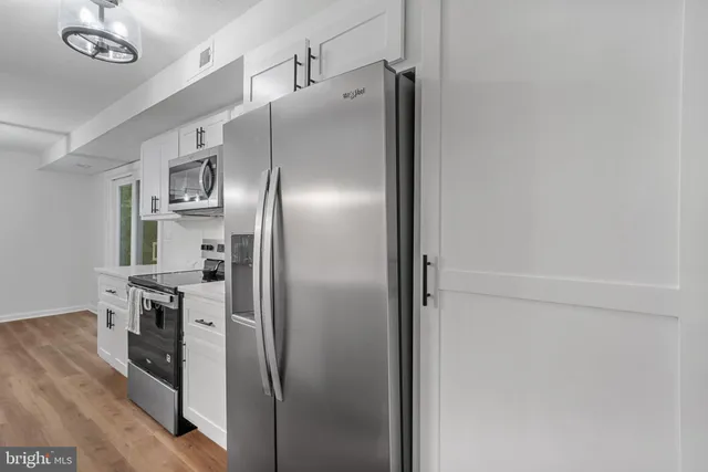 a metallic refrigerator freezer sitting in a kitchen
