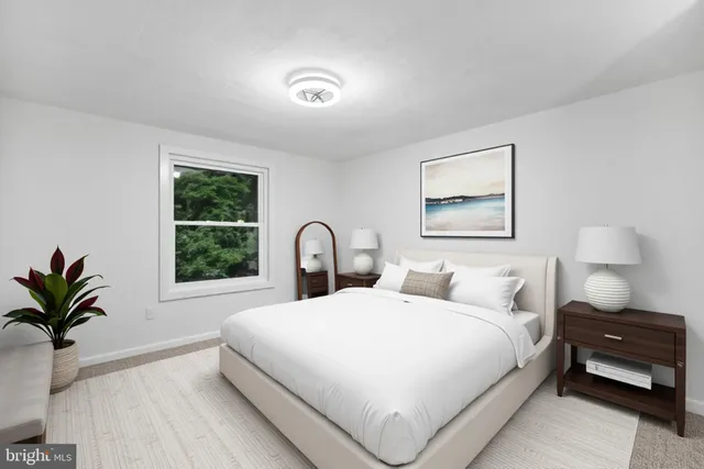 a bedroom with a large bed and a window